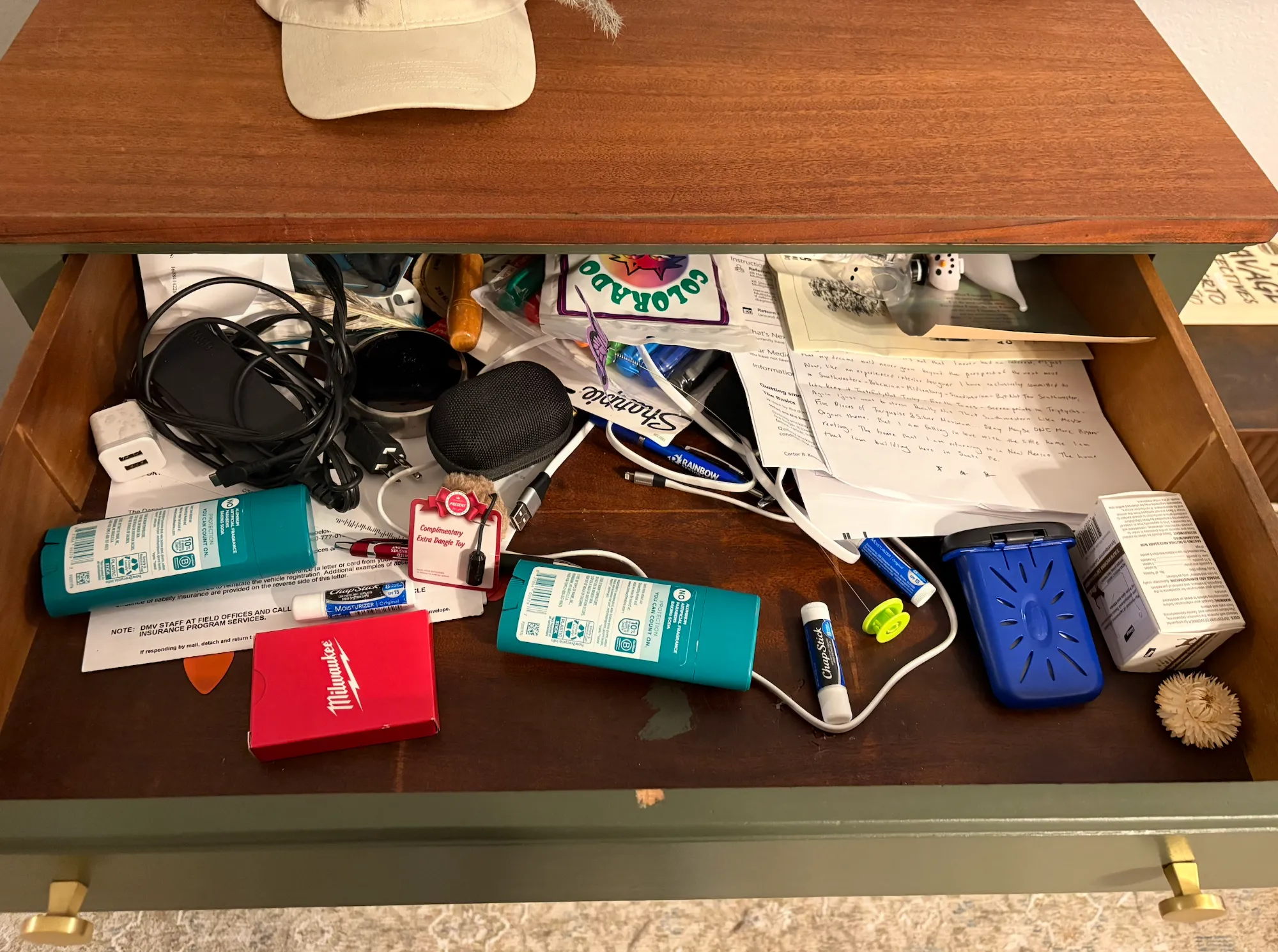 A messy junk drawer full of odds and ends