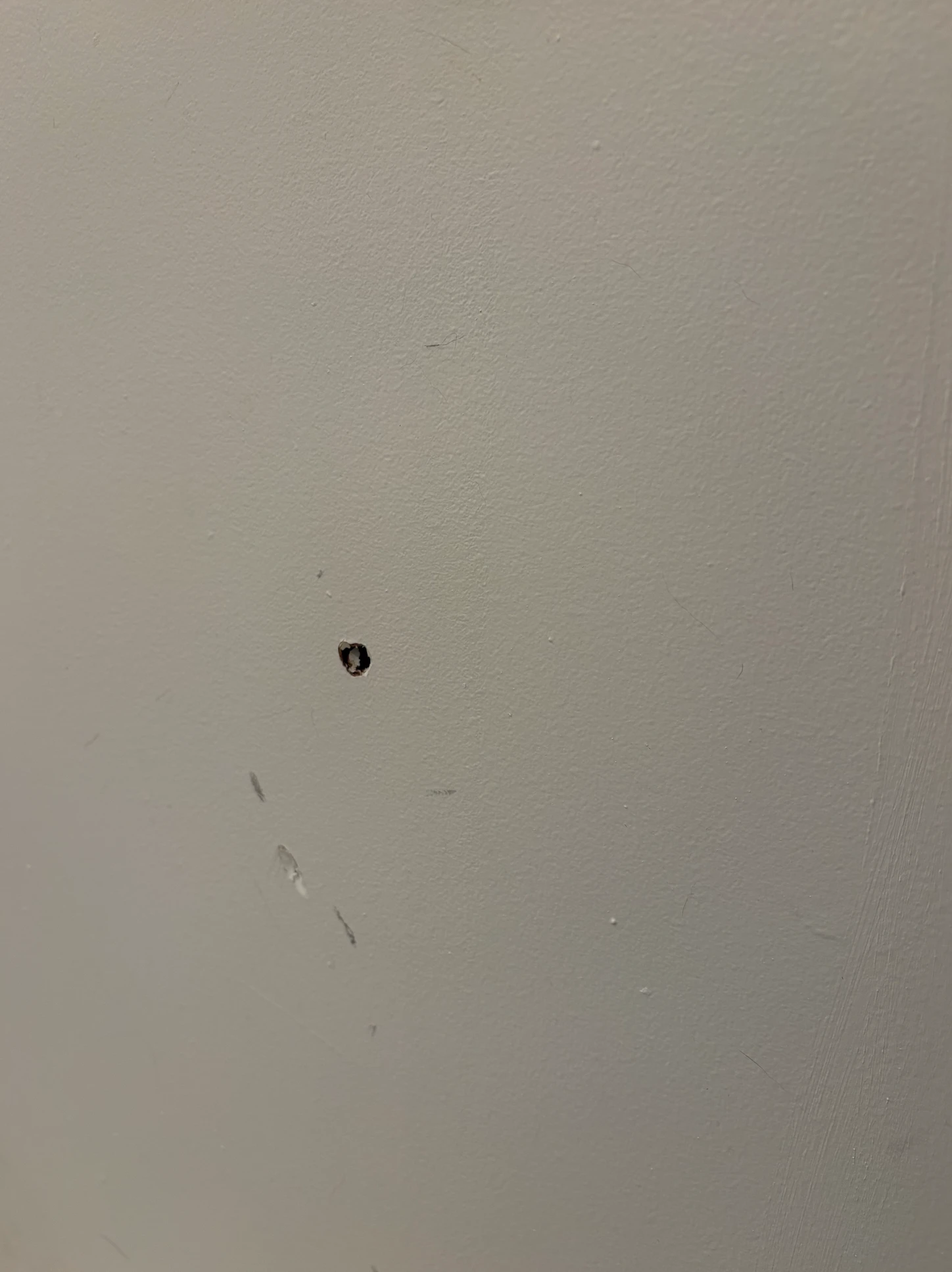 A hole in a white wall